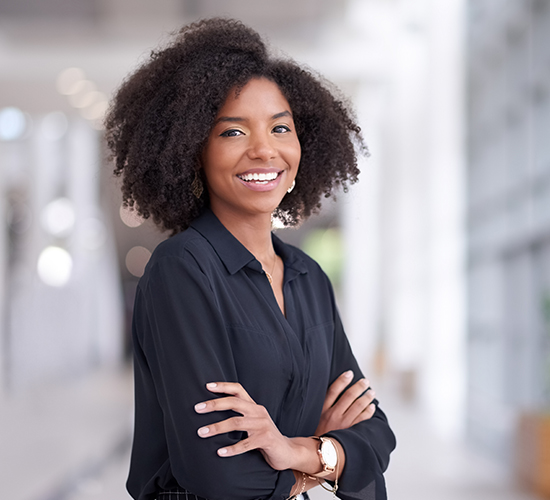 Smiling woman standing confidentl, highlighting Goel Vision's Best Price Guarantee for LASIK.