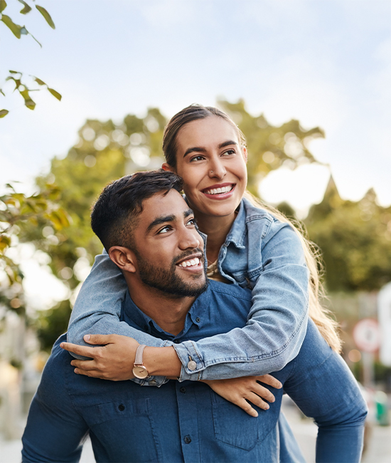 Happy couple outdoors showcasing life after successful LASIK surgery.