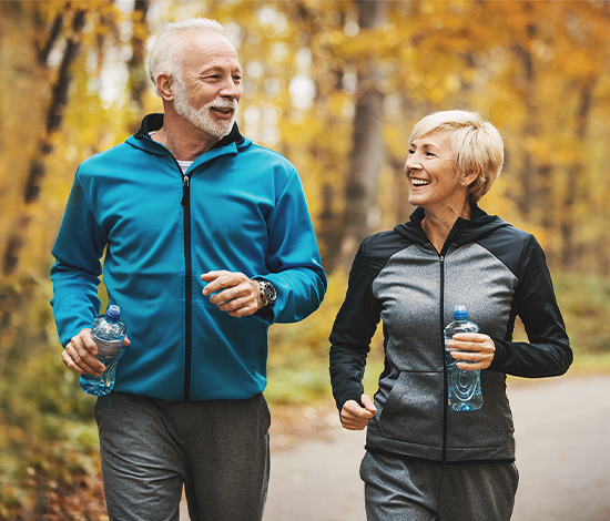 Couple enjoying a walk outdoors, highlighting the freedom and clearer vision after cataract surgery.