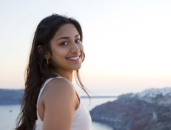 Smiling patient enjoying life after undergoing PRK surgery, looking at the horizon.