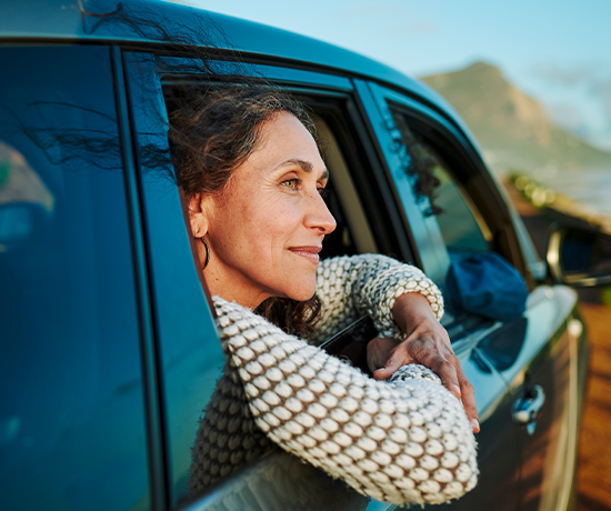 Woman enjoying a scenic drive, symbolizing the freedom and improved vision after RLE.