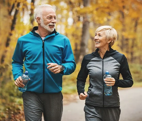 Couple enjoying a walk outdoors, highlighting the freedom and clearer vision after cataract surgery.