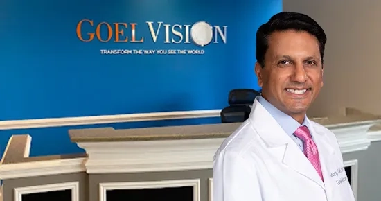 Dr. Sonny Goel standing in front of the Goel Vision logo, representing virtual consultations for LASIK and SMILE with the experienced surgeon.